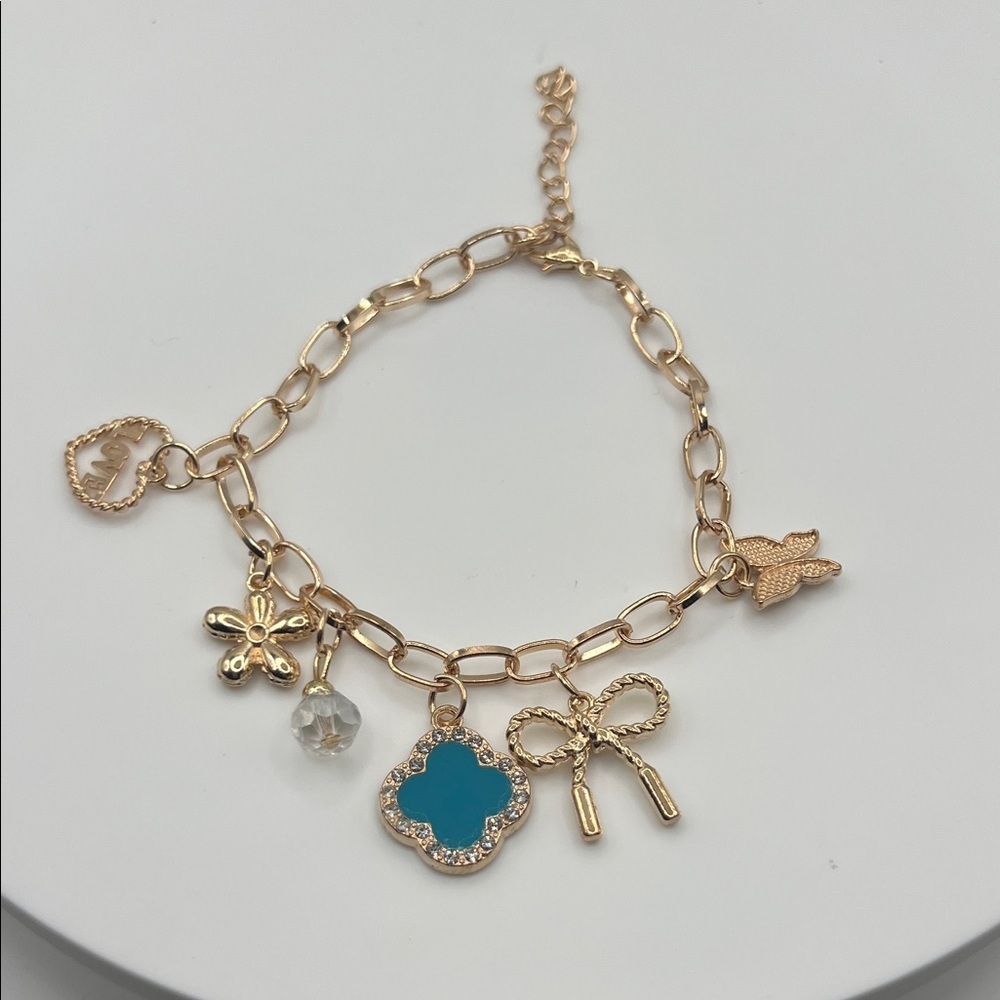 857.‎ Gold Charm Bracelet with Blue Accent